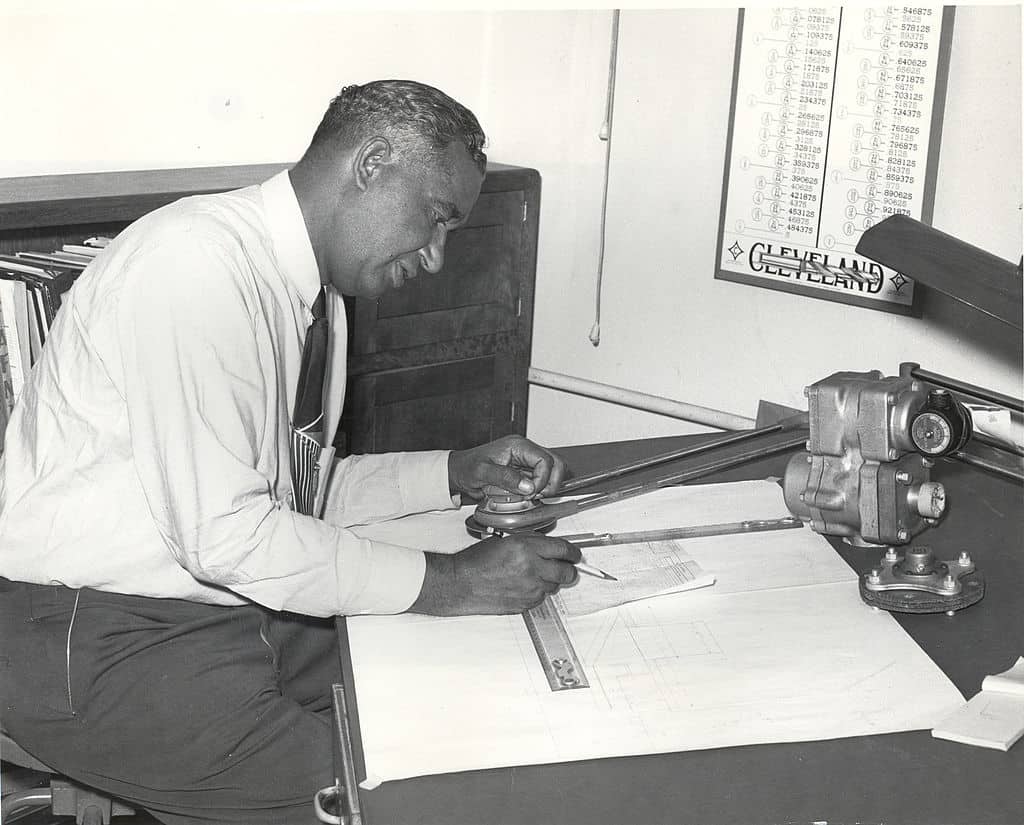 Fred McKinley Jones, innovator of mobile refrigeration trucking, works on schematics at a desk