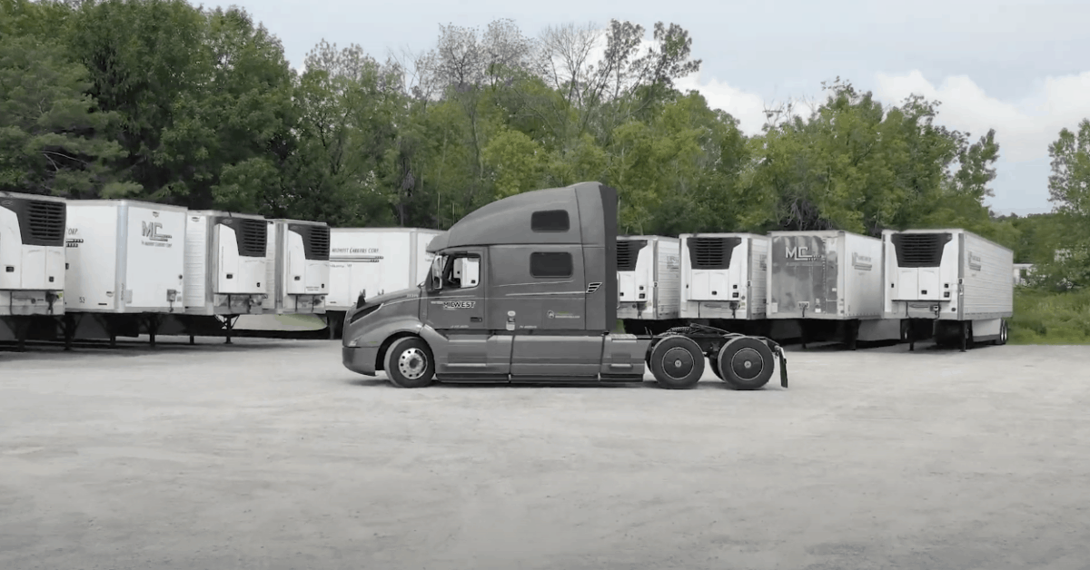 Midwest Carriers truck cab parked in fron a multiple trailers